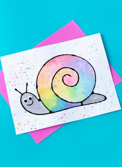 Learn how to make Black Glue and Watercolor Snail Art. This craft includes a free template, making it perfect for home or school.